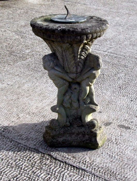 A well weathered reconstituted stone sundial, 54cms high.