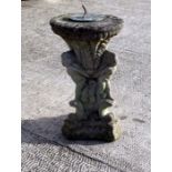A well weathered reconstituted stone sundial, 54cms high.