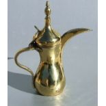 A large Turkish / Islamic brass dallah coffee pot, 39cms high.