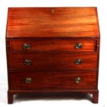 An early 19th century mahogany bureau, the fall-flap enclosing a fitted interior with three