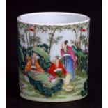 A Chinese Republic famille rose brush pot decorated with figures in a bamboo grove, 8cms high.