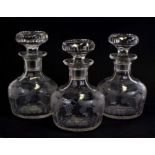 A set of three late 19th / early 20th century etched glass decanters etched with scrolling vines and
