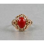 A 14ct gold dress ring set with a coral cabochon, weight 3.5g, approx UK size 'P.