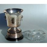 A large silver mounted cut glass ashtray, 20cms diameter; together with a silver plated trophy ice