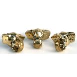 A set of three cast brass elephant heads, each 20cms wide (3).