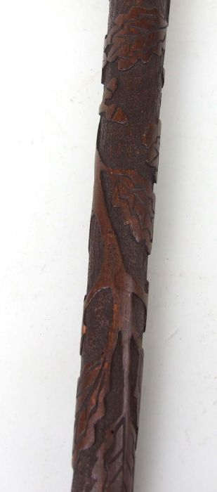 A WWI POW carved walking stick, carved with script, oak leaves and Iron crosses, 85cms long. - Image 4 of 4