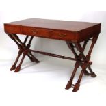 A Campaign style mahogany writing table with brass bound corners and brass inlay, on a double 'X'