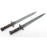 An English 1888 Pattern bayonet together with another similar. Both blade lengths of 30.5cms (