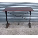 A rectangular garden table on cast iron supports, 109cms wide.Condition Report62cms depth, 109cms