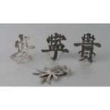 A set of four Chinese silver menu holders, each in the form of a Chinese character, finely