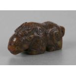 A Chinese carved russet jade carving of a ram with Archaic style engraving, 7cms long.