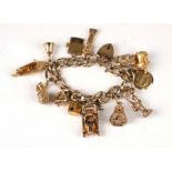 A 9ct gold charm bracelet with fourteen gold charms to include a motor car, a stick telephone, a