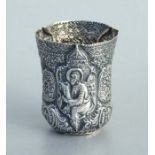 An Ottoman / Greek white metal beaker highly decorated in relief with religious figures, 9cms high.