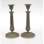 A pair of Empire style brass candlesticks, 26cms high.