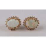 A pair of 14ct gold, opal and diamond stud earrings.