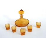 An Art Deco faceted amber glass liqueur set, the decanter 21cms high; together with five glasses.