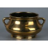 A Chinese polished bronze censer with lug handles, six character mark to base, 11cm diameter, 345g