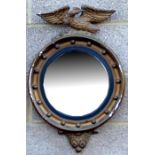 A gilt gesso convex wall mirror surmounted with an eagle, overall 43cms diameter.