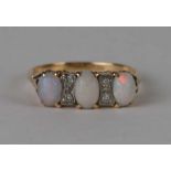 An 18ct gold opal and diamond ring with three oval opal cabochons interspersed with four diamonds,