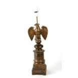 A French brass table lamp with an eagle with outstretched wings, overall 52cms high.