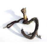 A Chinese bronze ‘Pet’ dragon with brass collar and leather lead, 29cms long.