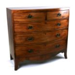 A Regency mahogany bowfronted chest of two short and three graduated long drawers, on splay