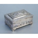 An Indian silver box and cover decorated in relief with animals and figures, 13cms wide, weight