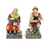A pair of Staffordshire pearlware figures of the Cobbler and his wife c.1820, both seated, she