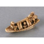 A 19th century Japanese ivory netsuke in the form of figures in a boat, two character mark to the