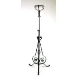An Arts & Crafts style wrought iron rise-and-fall standard lamp; together with a wrought iron