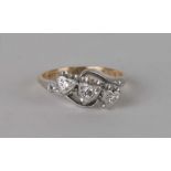 An 18ct gold and platinum diamond heart shaped crossover ring, approx. UK size N. 3.4g