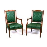 A pair of late 19th century inlaid mahogany armed chairs with upholstered seats and backs, on square