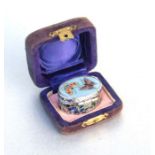 A White metal and enamel oval box with cloisonne enamel top depicting two butterflies, in original