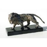 A large early 20th century silvered metal figure of a roaring lion standing on a black marble