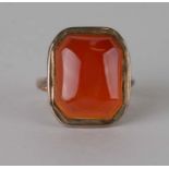 A 9ct rose gold ring set with a large rectangular carnelian, approx UK size 'K', 6.3g.
