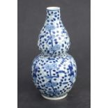 A Chinese blue & white double gourd vase decorated with figures amongst scrolling foliage, 25cms