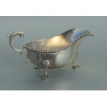 A George V silver sauce boat on shell pad feet, Chester 1913, 18cms long, 245g.