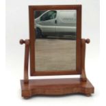 An Edwardian mahogany toilet mirror, 27cms wide.