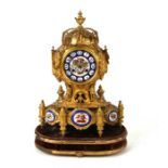 A 19th century continental gilt metal mantle clock, the painted enamel dial with Roman numerals, the