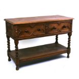 An oak buffet with two frieze drawers with geometric mouldings above an under-tier joined by