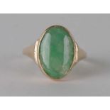 A yellow metal (test as 18ct) ring set with an oval jade cabochon, approx UK size 'T', 5.6g.