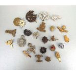 An assortment of twenty three early to mid 20th century British Military badges including Royal