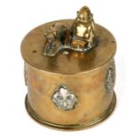 A WWI trench art tobacco jar and over with applied cap badges including RF, American North West