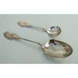 A large Dutch silver strainer serving spoon, 25cms long; together with a matching smaller sugar