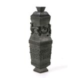 A Chinese bronze lozenge shaped vase and cover with Taotie masks to the body and chilong to the