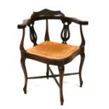 An Edwardian walnut corner chair with lyre splats.