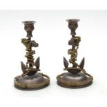 A pair of silver plate and brass nautical themed candlesticks, the columns in the form of anchors,