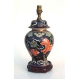 A Chinese, for the Thai market, vase and cover table lamp decorated with temple lions on a black