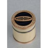 A Regency yellow metal mounted ivory counter box of cylindrical form, the blue enamel top with