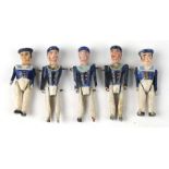 A set of five mid 19th century naïve carved jointed wooden dolls in Naval uniform Largest 6cm high(
